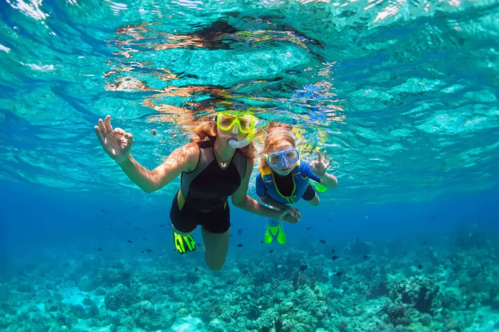 Private snorkeling tour group in crystal-clear water off Playa Flamingo, Costa Rica